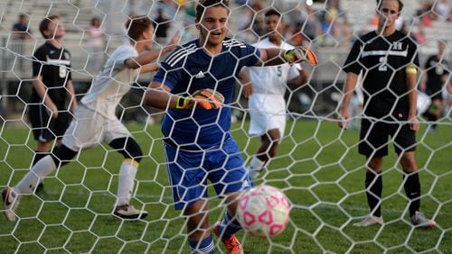 Howard High School’s goal keeper turns to watch the ball go into his net as Windsor Forest scores its third point of the game. Windsor Forest won the game 3-0. (Josh Galemore/Savannah Morning News via AP)