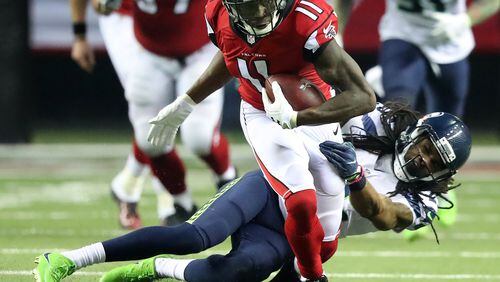 Falcons wide receiver Julio Jones makes a first down catch against Seahawks cornerback Richard Sherman during the third quarter in a NFL football NFC divisional playoff game on Saturday, Jan. 14, 2017, in Atlanta. Curtis Compton/ccompton@ajc.com