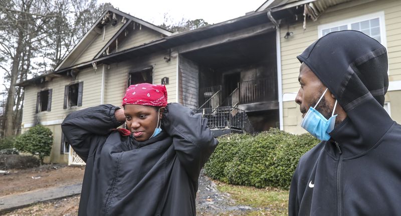 Residents of Orchard Walk in DeKalb County describe their escape from an overnight fire in February 2022. The website of the Frankforter Group, the Canadian firm that owned the complex at the time, proclaims average returns at 23%, which it achieves by "maximizing rental rates" and "rigorous operational controls to manage and reduce costs." (John Spink / John.Spink@ajc.com)

