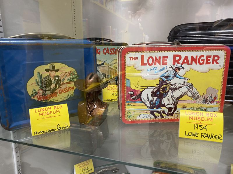 The Lunchbox Museum includes this pair of cowboy-oriented items. The Hopalong Cassidy lunch box was credited with sparking a craze among kids. Ligaya Figueras/ligaya.figueras@ajc.com