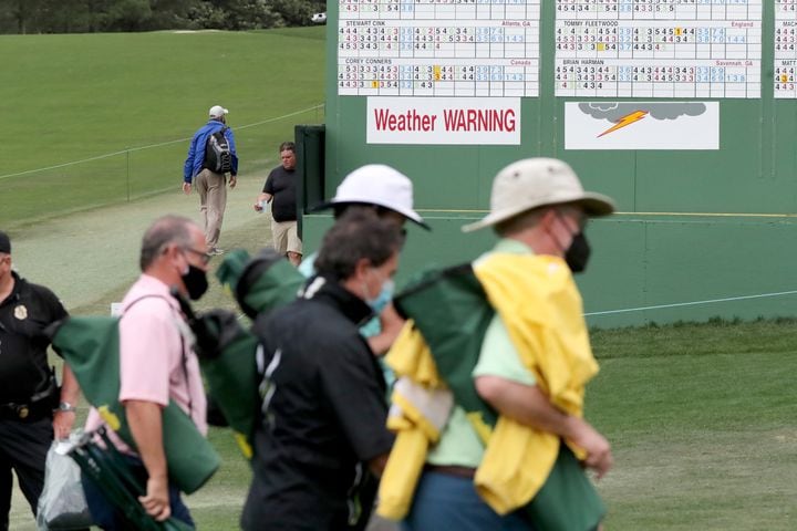 April 10, 2021, Augusta: Patrons leave the course as play is suspended because of a weather warning during the third round of the Masters at Augusta National Golf Club on Saturday, April 10, 2021, in Augusta. Curtis Compton/ccompton@ajc.com