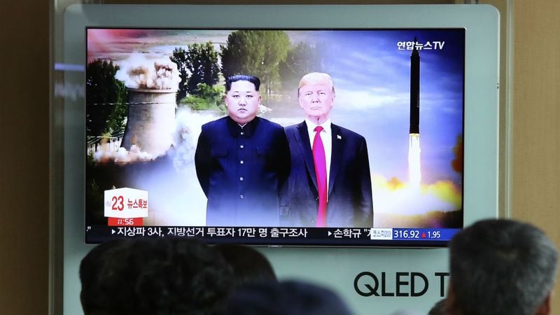 People watch a TV screen showing file footage of U.S. President Donald Trump, right, and North Korean leader Kim Jong Un during a news program at Seoul Railway Station in Seoul, South Korea, Monday, June 11, 2018. Final preparations are underway in Singapore for Tuesday's historic summit between President Trump and North Korean leader Kim, including a plan for the leaders to kick things off by meeting with only their translators present, a U.S. official said.