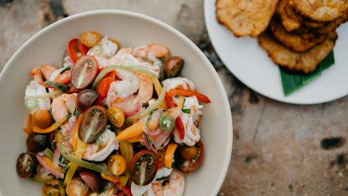 No other dish captures the beauty of Caribbean cuisine more than escabeche, writes chef and author Asha Gomez. The shrimp salad, at front, is pictured with tostones, fried green plantains, at rear. STYLING BY ASHA GOMEZ / CONTRIBUTED BY MEREDITH ZIMMERMAN