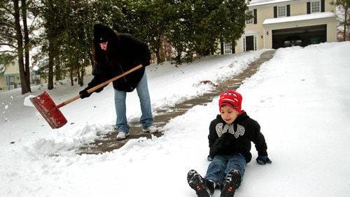 Snow days used to mean playing out in the cold stuff. With technology, though, many school systems have turned those times into work-from-home days. The AJC asks readers if every school should do that. AJC file photo