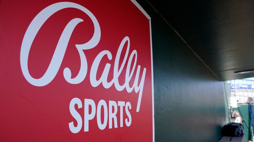 A Bally Sports logo is on a dugout wall during a spring training baseball game at Roger Dean Stadium, March 4, 2023, in Jupiter, Fla. Major League Baseball will take over broadcasts of San Diego Padres games beginning Wednesday, May 31. (AP Photo/Lynne Sladky, FIle)