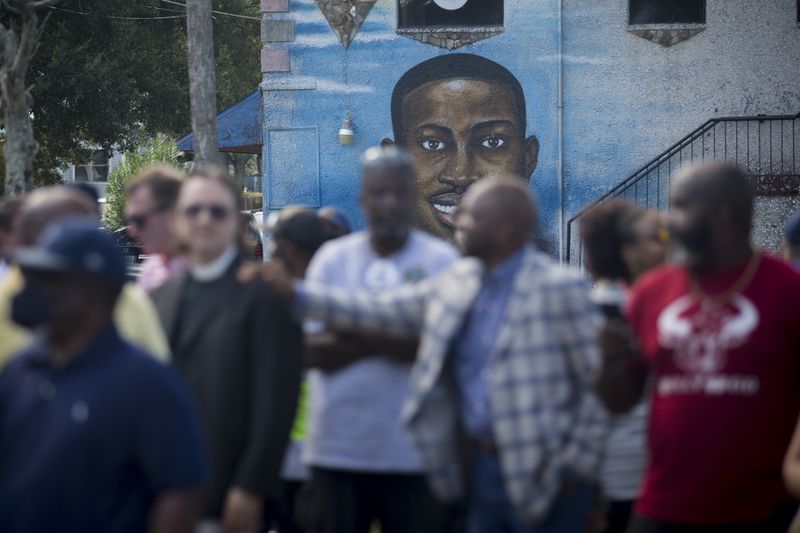 BRUNSWICK, GA - AUGUST, 9, 2022: Friends and family gather near Ahmaud Arbery's mural during an event commemorating his life in downtown Brunswick. (AJC Photo/Stephen B. Morton)