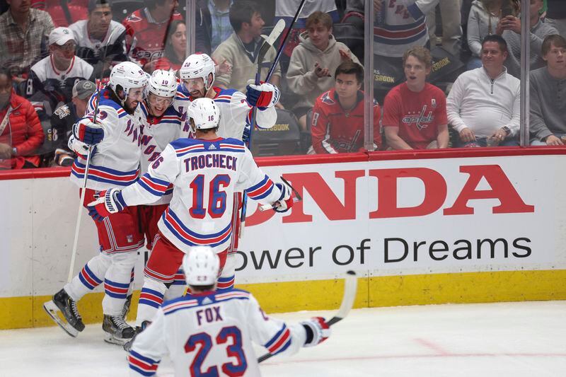 New York Rangers left wing Artemi Panarin, center, celebrates with teammates after scoring a goal during the third period in Game 4 of an NHL hockey Stanley Cup first-round playoff series against the Washington Capitals Sunday, April 28, 2024, in Washington. (AP Photo/Tom Brenner)