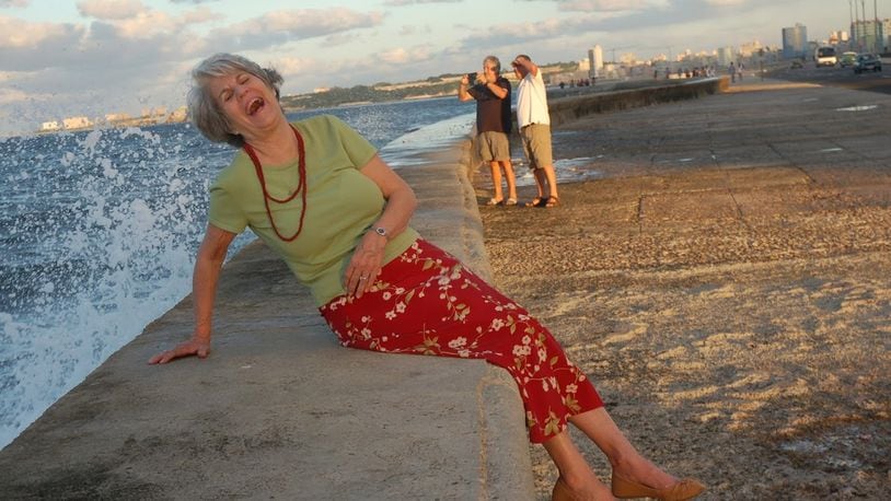 The writer’s wife, Eileen Osinski, reconnects with her Cuban heritage on the Malecon, a seven mile-long seawall along Havana’s northern shore. PHOTO CREDIT: Bill Osinski