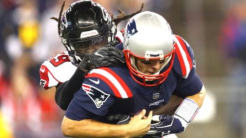 Falcons linebacker De'Vondre Campbell sacks Patriots quarterback Tom Brady in the first quarter of Sunday night's game at Gillette Stadium in Foxboro, Massachusetts.