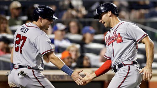 Atlanta Braves' Austin Riley (27) and Matt Olson, right, celebrate after scoring against the New York Mets during the eighth inning in the second baseball game of a doubleheader on Saturday, Aug. 12, 2023, in New York. (AP Photo/Adam Hunger)