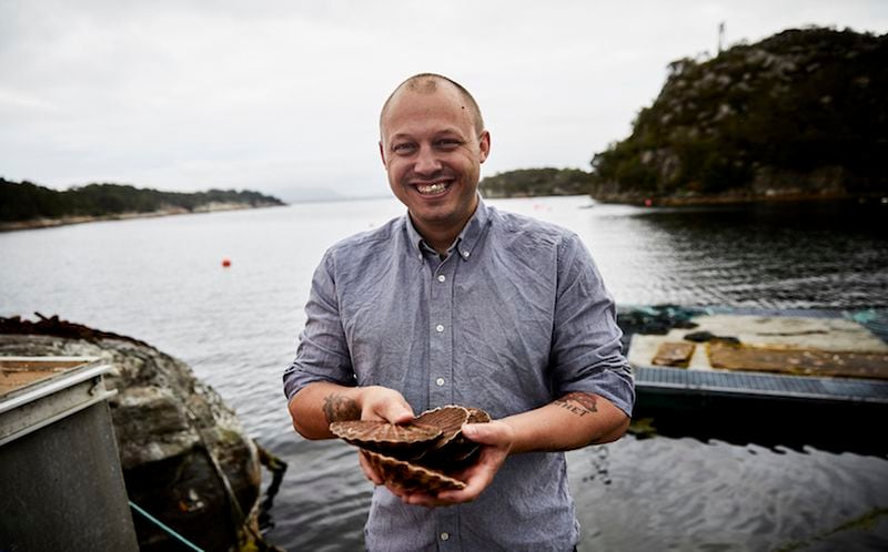 Christopher Haatuft, chef at his restaurant Lysverket, with scallops from the fjord near Bergen, on the west coast of Norway in July of 2017. New Nordic chefs are guided by solemn manifestoes about nature and culture, and often restrict themselves to Scandinavian ingredients. Haatuft, who is the opposite of solemn, coined a new term for the food at his restaurant: neo-fjordic. (David B. Torch/The New York Times)