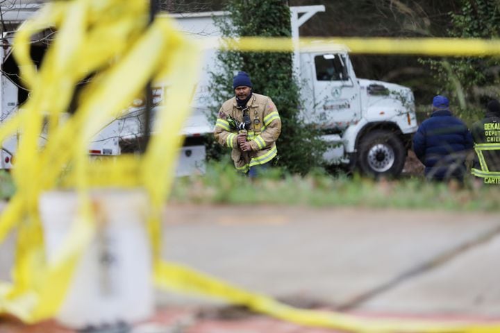 A Dekalb County fire department member walks in the house's driveway where a tree fell in the early hours, killing a 5-year-old boy and sending his mother to the hospital. Monday, January 3, 2022. Miguel Martinez for The Atlanta Journal-Constitution