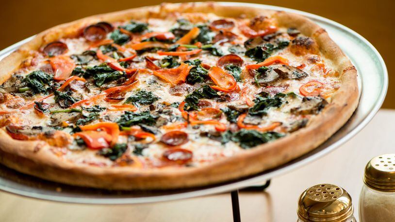 A 16-inch Junior’s Pizza pie with pepperoni, red bell peppers, mushrooms and spinach. CONTRIBUTED BY MIA YAKEL