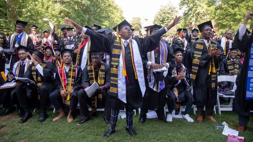 Graduates react after hearing billionaire Robert F. Smith is paying all student debt for the Class of 2019 during the  Morehouse College graduation ceremony in Atlanta on Sunday, May 19, 2019. STEVE SCHAEFER / SPECIAL TO THE AJC