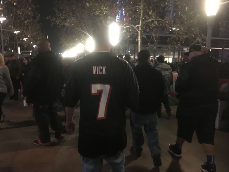  Walk around the Super Bowl fan plaza for a while, and you'll spot a Vick jersey here and there. Photo: Jennifer Brett, jbrett@ajc.com