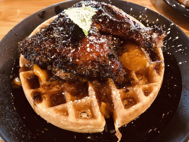 A fat Belgian waffle with jerk chicken and peach compote is a winning sweet-savory dish at the Real Milk & Honey in College Park. CONTRIBUTED BY WENDELL BROCK