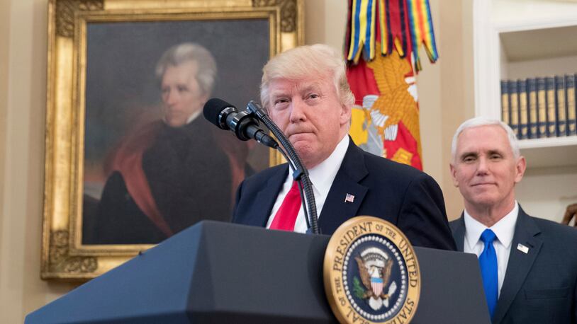 FILE - In this March 31, 2017 file photo, a portrait of former President Andrew Jackson hangs on the wall behind President Donald Trump, accompanied by Vice President Mike Pence, in the Oval Office at the White House in Washington. President Donald Trump made puzzling claims about Andrew Jackson and the Civil War in an interview, suggesting that he was uncertain about the origin of the conflict while claiming that Jackson was upset about the war that started more than a decade after his death.  (AP Photo/Andrew Harnik, File)