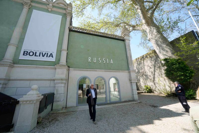 A visitor walks in front of the Russian pavilion at the 60th Biennale of Arts exhibition in Venice, Italy, Tuesday, April 16, 2024. The Venice Biennale contemporary art exhibition opens Saturday for its six-month run through Nov. 26. The main show titled 'Stranieri Ovunque – Foreigners Everywhere' is curated for the first time by a Latin American, Brazilian Adrian Pedrosa. Pedrosa is putting a focus on underrepresented artists from the global south, along with gay and Indigenous artists. Alongside the main exhibition, 88 national pavilions fan out from the traditional venue in Venice's Giardini, to the Arsenale and other locations scattered throughout the lagoon city. (AP Photo/Luca Bruno)