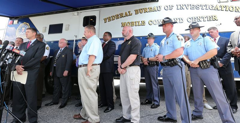 Commissioner Greg Dozier (left), Georgia Department of Corrections, speaks to the news media during a joint press conference of all the agencies involved in the manhunt for the two escaped convicts Donnie Russell Rowe and Ricky Dubose, who shot and killed two correctional officers, at the Morgan County Public Safety Complex on Thursday, June 15, 2017, in Madison. Curtis Compton/ccompton@ajc.com