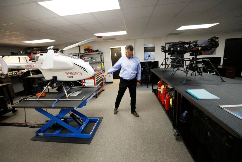 William E. Lovett, Managing Director, Phoenix Air Unmanned, shows the type of aircraft the company is planning to use for utility work for energy companies in metro Atlanta. The Swiss Drone SDO 50V2 maximum take off weight is 191 pounds, left, and FreeFly ALTA X. maximum take off Weight is restricted to 54.9 pounds under FAA, Part 107 regulation.  