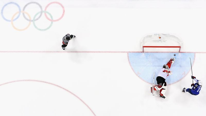 United State's Jocelyne Lamoureux slides the puck past Canada goalkeeper Shannon Szabados for the game-winner in the Women's Gold Medal Game at the PyeongChang 2018 Winter Olympic Games in Gangneung, South Korea.
