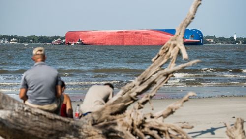 People watch from Jekyll Island as emergency responders work to rescue crew members from a capsized cargo ship on September 9, 2019 in St Simons Island, Georgia. A 656-foot vehicle carrier, the M/V Golden Ray departed the Brunswick port and suffered a fire on board, capsizing in St. Simons Sound. (Photo by Sean Rayford/Getty Images)