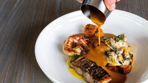 The Aix Bouillabaisse is made with a variety of seafood, but what’s really special is the saffron-tinged broth. CONTRIBUTED BY HENRI HOLLIS