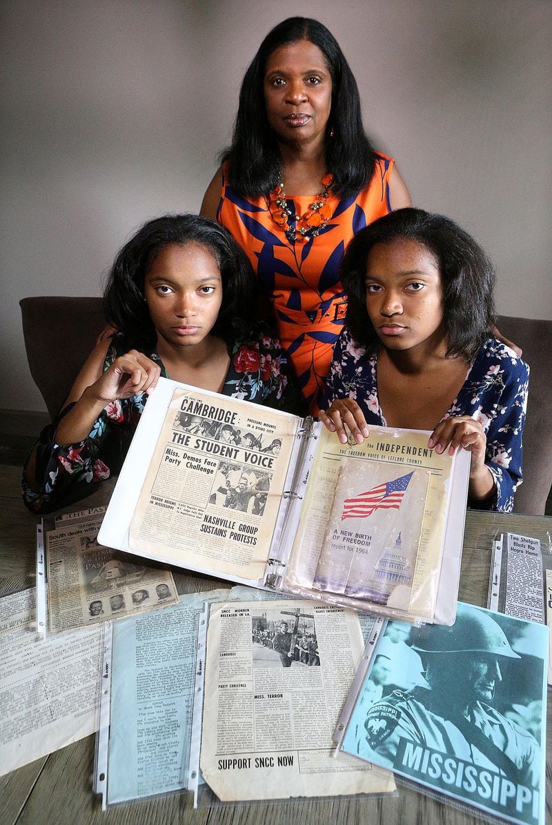 Angela Greene-Johnson connected her daughters, Sharena (left) and Malia Johnson, both 17, with information about her father’s family in Mississippi when the twins worked on their civil rights family heritage project in 2011. CURTIS COMPTON / CCOMPTON@AJC.COM