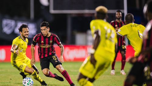 Atlanta United's Ezequiel Barco (8) attempts to penetrate the Columbus defense Tuesday, July 21, 2020, during MLS tournament in Orlando, Fla.