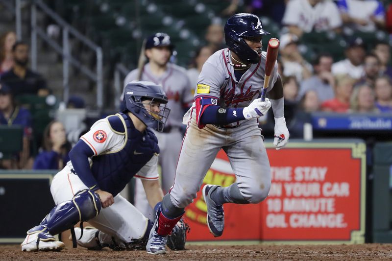 Atlanta Braves's Michael Harris II, right, flips his bat in front of Houston Astros catcher Yainer Diaz as he watches his RBI single during the ninth inning of a baseball game Monday, April 15, 2024, in Houston. (AP Photo/Michael Wyke)