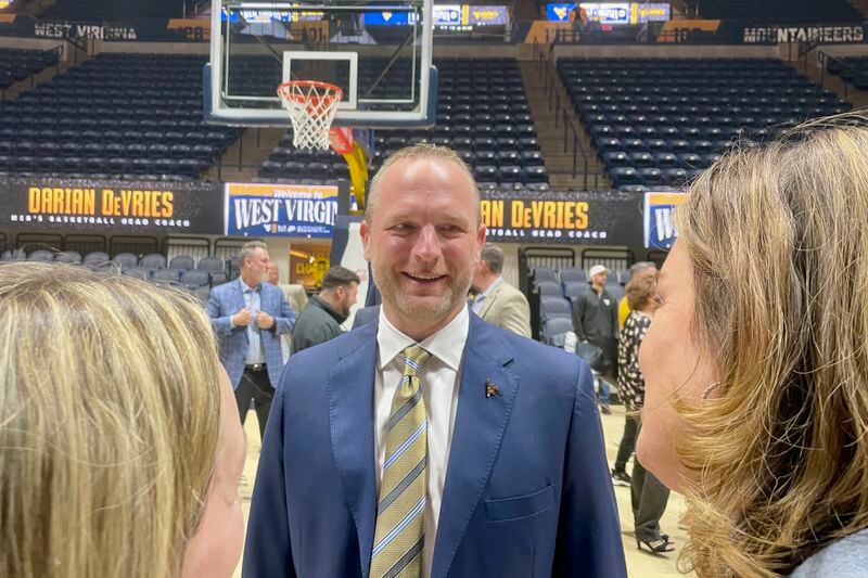 New West Virginia men's NCAA college basketball coach Darian DeVries talks with fans after an introductory news conference Thursday, March 28, 2024, in Morgantown, W.Va. (AP Photo/John Raby)