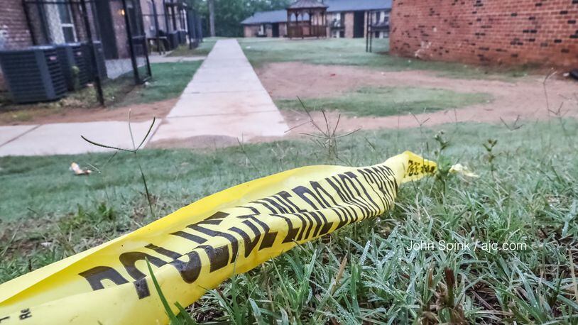 Crime scene tape remains at the site of a triple shooting investigation at an apartment complex in southwest Atlanta. One month later, someone fired multiple rounds into a single mother’s apartment while her four children were inside.
