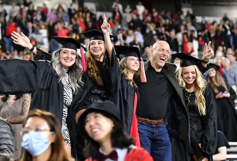 October 16, 2020 Athens - Graduates and family members sing Alma Mater as they stay in the stands during the 2020 Spring Undergraduate Commencement ceremony at Sanford Stadium in Athens on Friday, October 16, 2020. (Hyosub Shin / Hyosub.Shin@ajc.com)