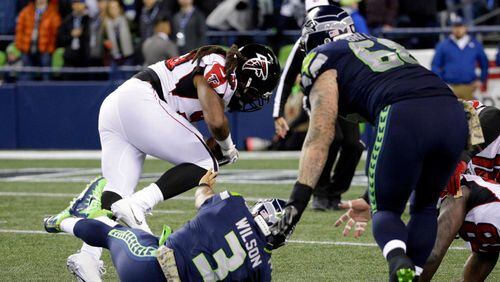 Atlanta Falcons' Adrian Clayborn races away with the ball for a touchdown after scooping up a fumble by Seattle Seahawks quarterback Russell Wilson (3) after Wilson was sacked in the first half of an NFL football game, Monday, Nov. 20, 2017, in Seattle. (AP Photo/Ted S. Warren)