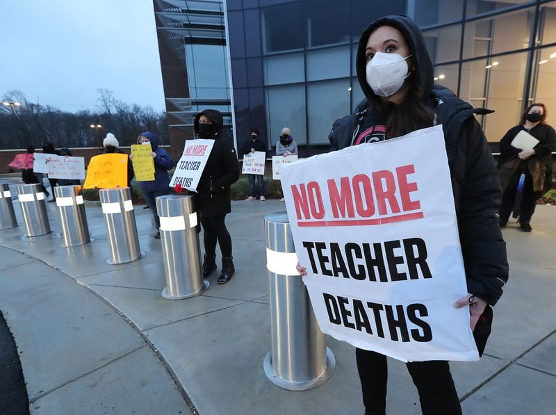 012121 Marietta: School counselor Jennifer Susko (right) is one of hundreds of Cobb County teachers and staff holding a protest in the parking lot during the school board meeting at the Cobb County School District's Offices on Thursday, Jan. 21, 2021, in Marietta. Cobb teachers are pressing the district for improved COVID-19 response.  Curtis Compton / Curtis.Compton@ajc.com”