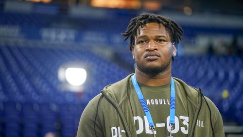 Georgia defensive lineman Jalen Carter watches as players warm up on the field before the NFL football scouting combine in Indianapolis, Thursday, March 2, 2023. (AP Photo/Darron Cummings)