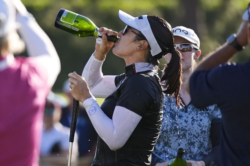 Hannah Green drinks champagne after winning the LPGA's JM Eagle LA Championship golf tournament at Wilshire Country Club, Sunday, April 28, 2024, in Los Angeles. (AP Photo/Ashley Landis)