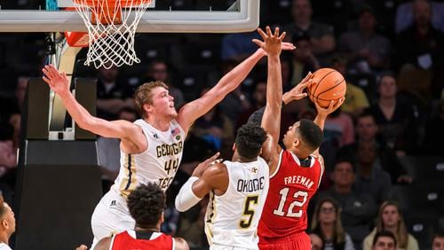 Georgia Tech center Ben Lammers (44) and guard Josh Okogie (5) defend against a shot by North Carolina State guard Allerik Freeman (12) in the first half of an NCAA college basketball game in Atlanta, Thursday, March 1, 2018. (AP Photo/Danny Karnik)
