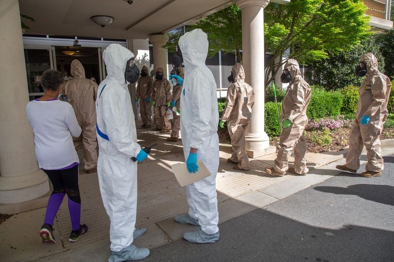 The 265th Infectious Control GA Army National Guard enters the Canterbury Court, a senior living facility in Buckhead, to disinfect the building on Friday, April 10, 2020. STEVE SCHAEFER / Special to the AJC