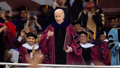 President Joe Biden points at alumni at the commencement ceremony at Morehouse College in Atlanta on Sunday, May 19, 2024. (Arvin Temkar / AJC)