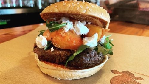 The seasonal peach burger at Farm Burger features peaches and goat cheese from local farms. Courtesy of Farm Burger