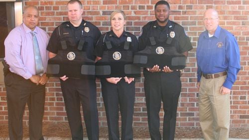 Representatives of the Georgia Fraternal Order of Police present three ballistic vests to the Ashburn Police Department. Telemarketers who raise money for the order tell potential donors that money is needed for vests, to help families of injured officers and to pay operating expenses. But most donations go to the commercial fundraisers.