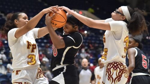 March 11, 2021 Macon - Woodward Academy's Zoe Scott (20) holds onto a ball as Forest Park's Jasmine Stevens (3) and Forest Park's Yasmine Allen (right) try to steal during the 2021 GHSA State Basketball Class 5A Girls Championship game at the Macon Centreplex. (Hyosub Shin / Hyosub.Shin@ajc.com)