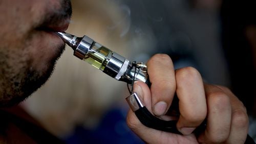 The city of Marietta will consider banning the  use of e-cigarettes at its parks and along sidewalks.