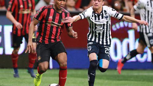 Atlanta United midfielder Darlington Nagbe, the man on the match, works the ball against Monterrey defender Jonathan Gonzalez in a Concacaf Champions league quarterfinal match on Wednesday, March 13, 2019, in Atlanta.    Curtis Compton/ccompton@ajc.com
