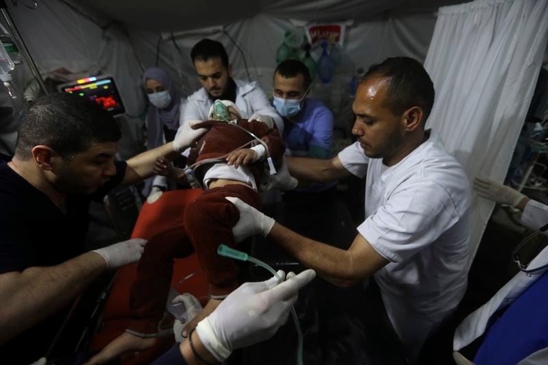 Palestinians carry the wounded in the Israeli bombardment of the Gaza Strip, to the Kuwaiti Hospital in Rafah refugee camp, southern Gaza Strip, Saturday, April 20, 2024. (AP Photo/Ismael Abu Dayyah)
