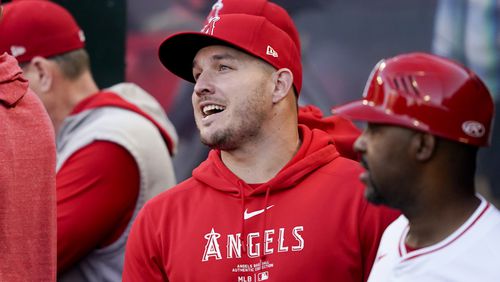 Los Angeles Angels center fielder Mike Trout speaks with teammates in the dugout before a baseball game against the Philadelphia Phillies, Tuesday, April 30, 2024, in Anaheim, Calif. (AP Photo/Ryan Sun)