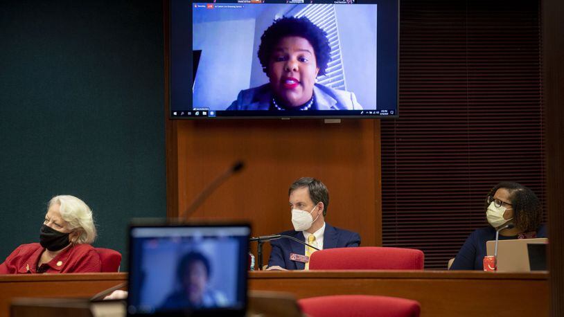 Democratic state Reps. Mary Margaret Oliver of Decatur, left, Bob Trammell of Luthersville and Renitta Shannon of Decatur listen Thursday as Fulton County poll worker Jacoria Borders, on an online video call, discusses the issues she faced during the recent primary election in testimony before the House Governmental Affairs Committee. (ALYSSA POINTER / ALYSSA.POINTER@AJC.COM)
