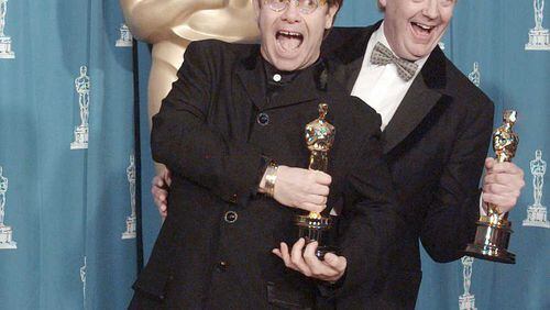 Elton John and Tim Rice hold their Oscars for Original Song backstage at the 67th annual Academy Awards at the Shrine Auditorium in Los Angeles on March 27, 1995. AP Photo