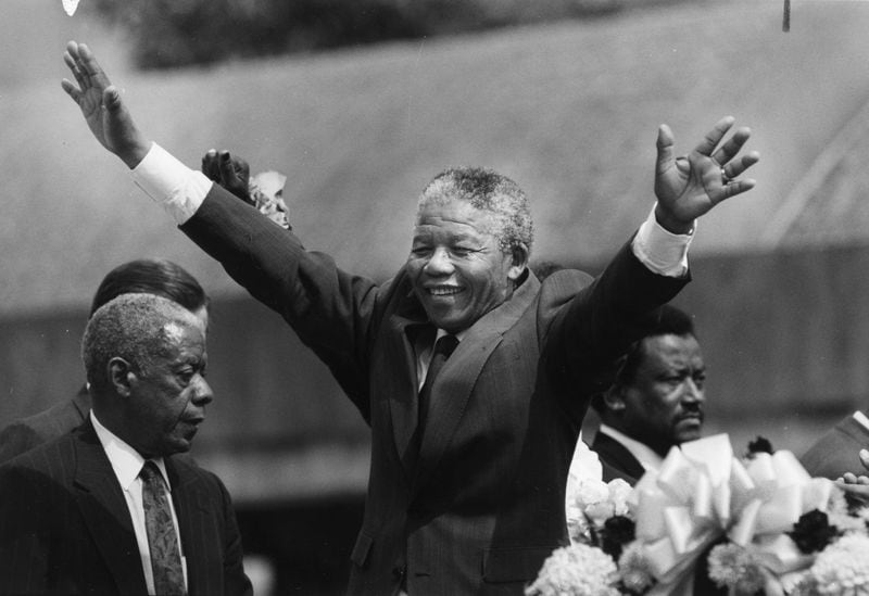 Nelson Mandela waves to the crowd after placing a wreath at the crypt of the Rev. Martin Luther King Jr. in Atlanta on June 27, 1990. His speech at Morehouse that day was marred by confusion amid a battle of college president egos.